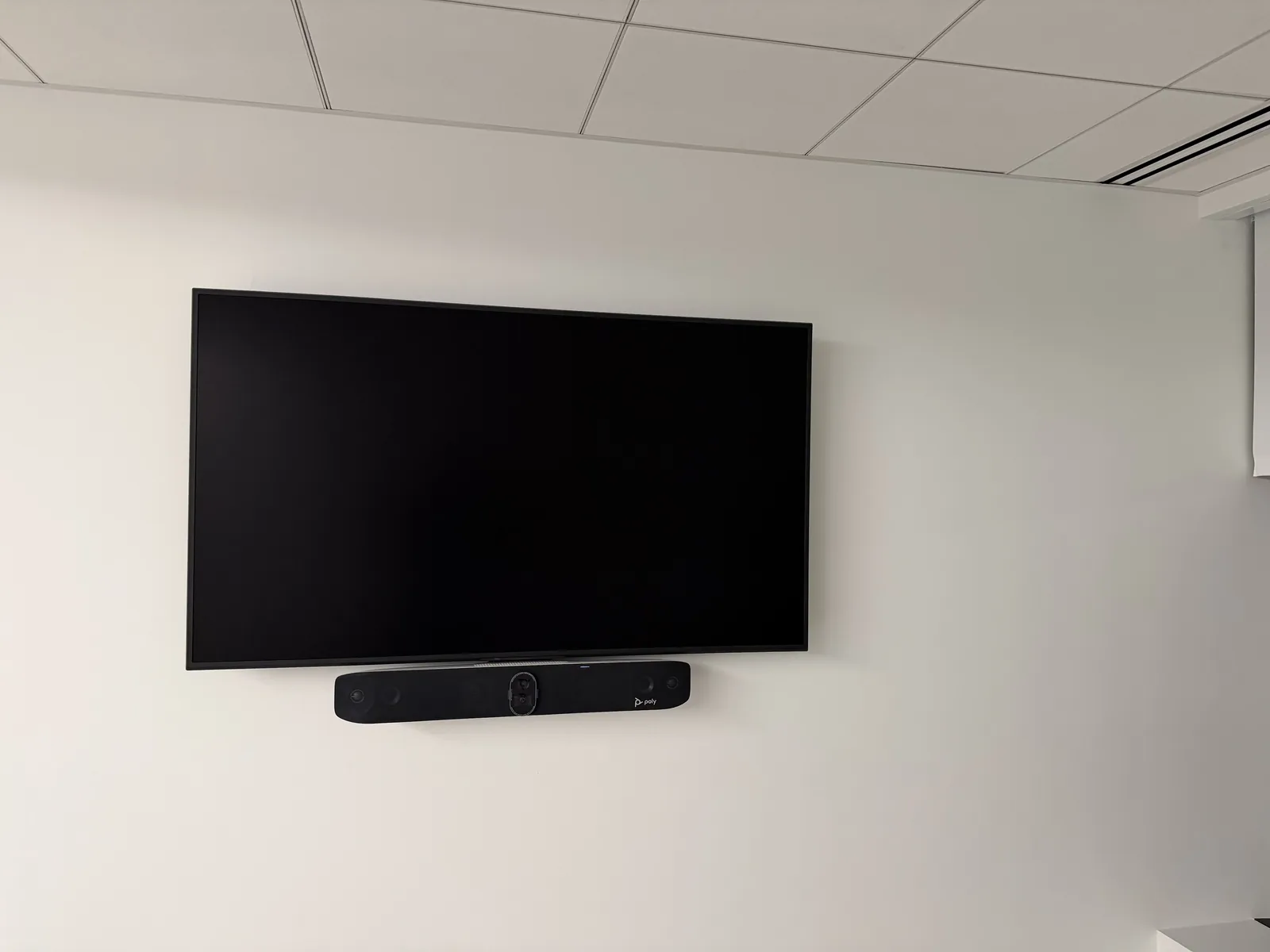Wall-mounted display with a soundbar
