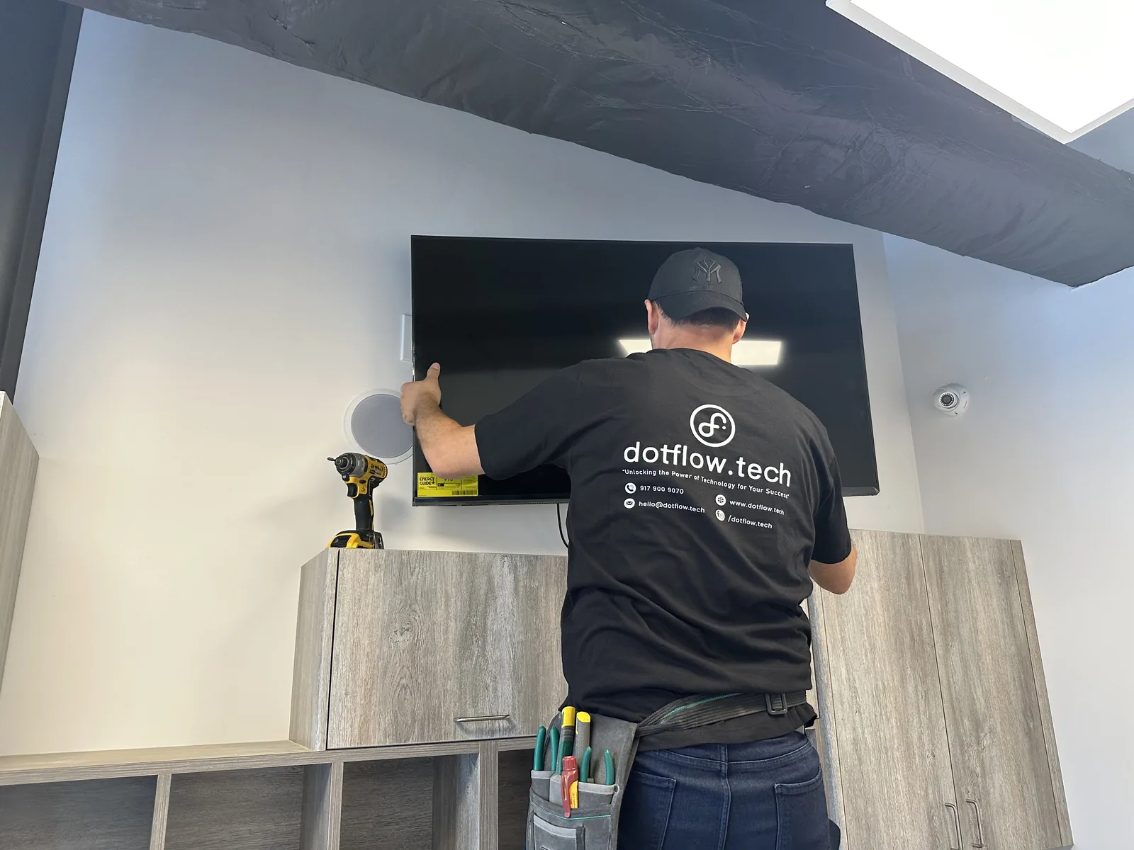 Technician mounting a display