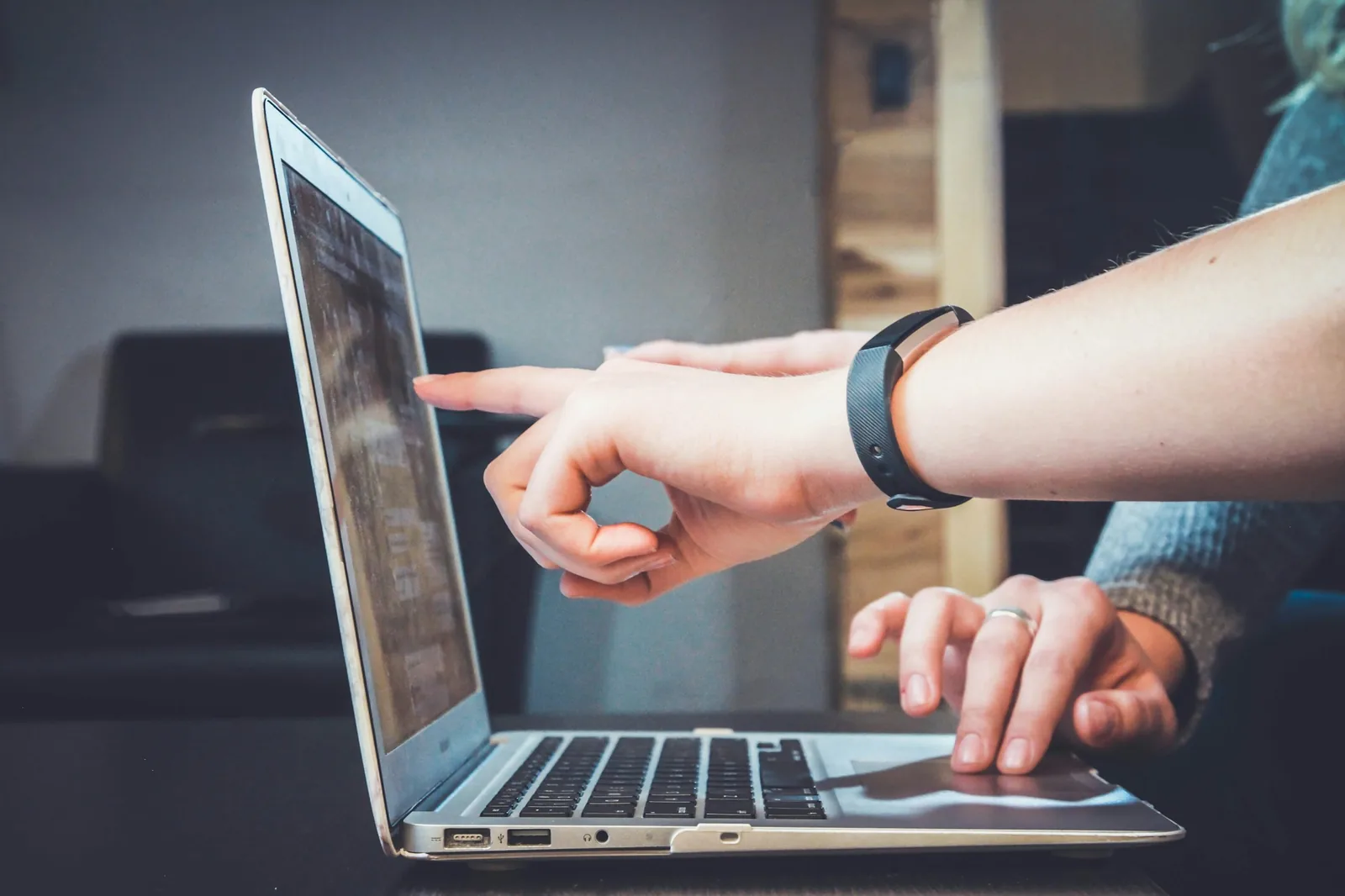 Hands working on a laptop