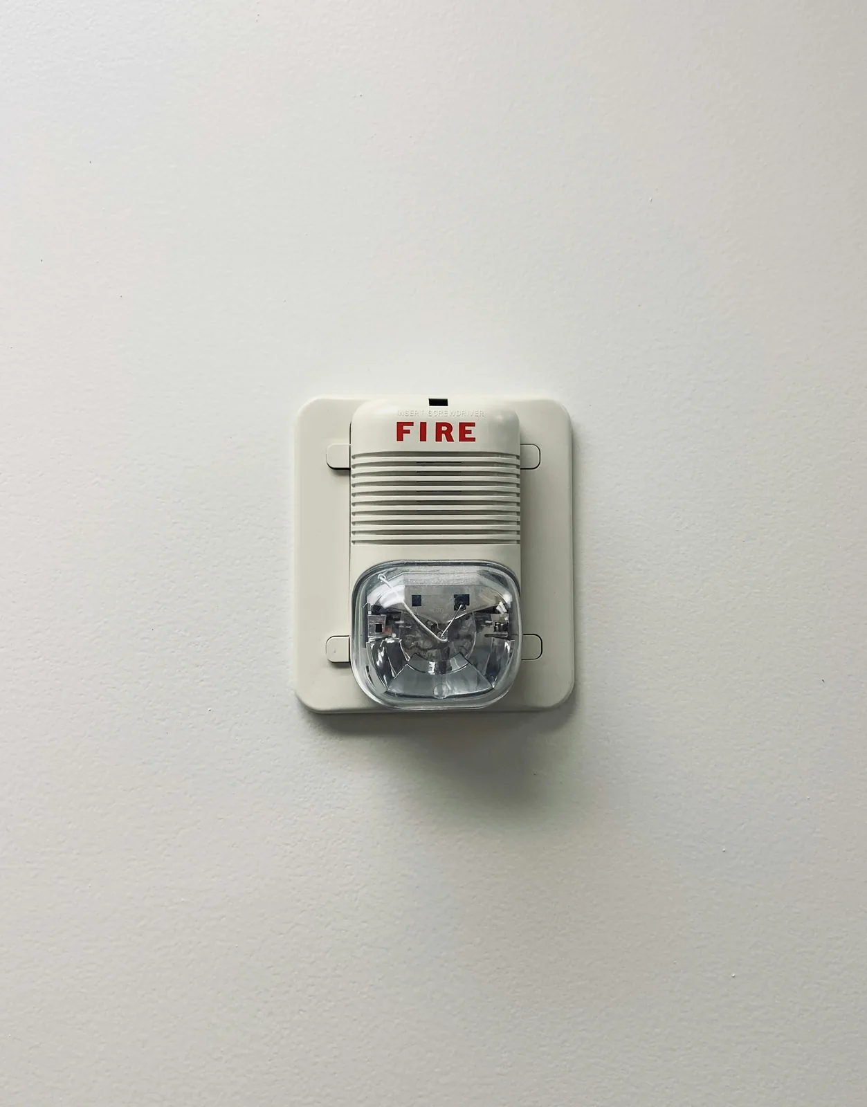 Wall-mounted fire alarm horn and strobe