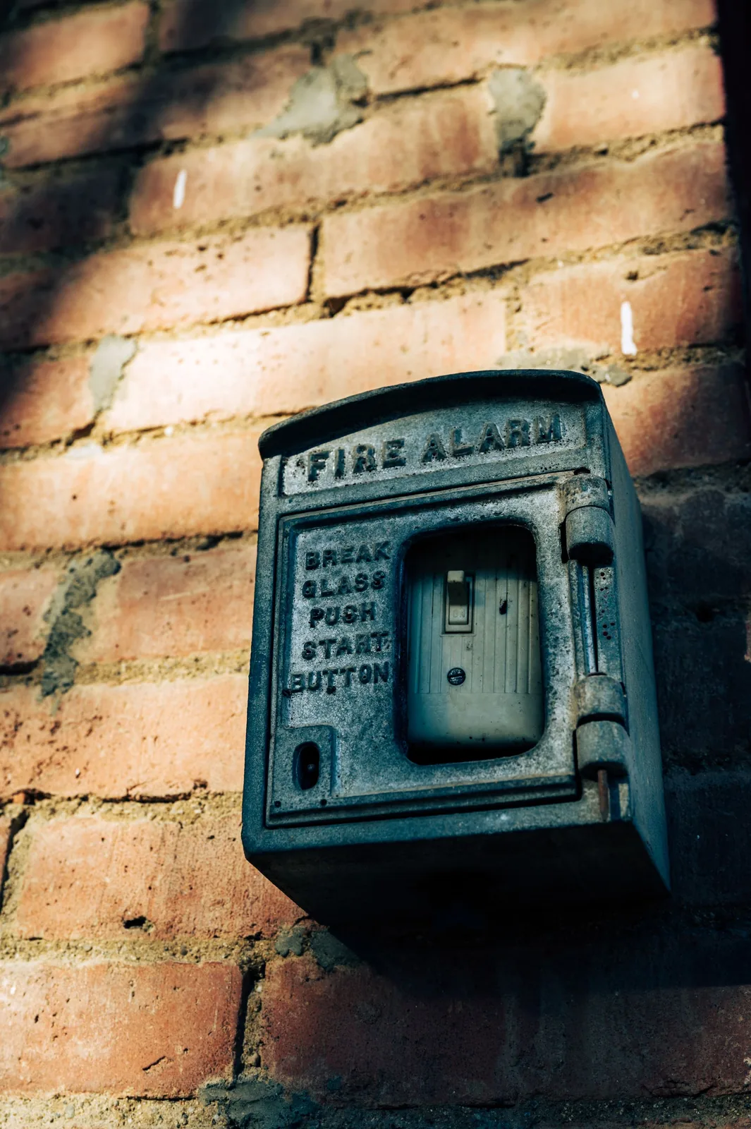 Vintage fire alarm station on brick