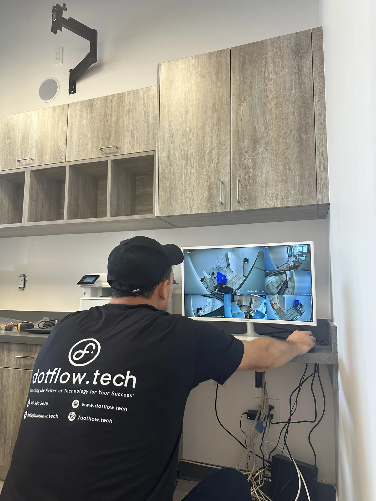 Technician at a camera monitoring wall