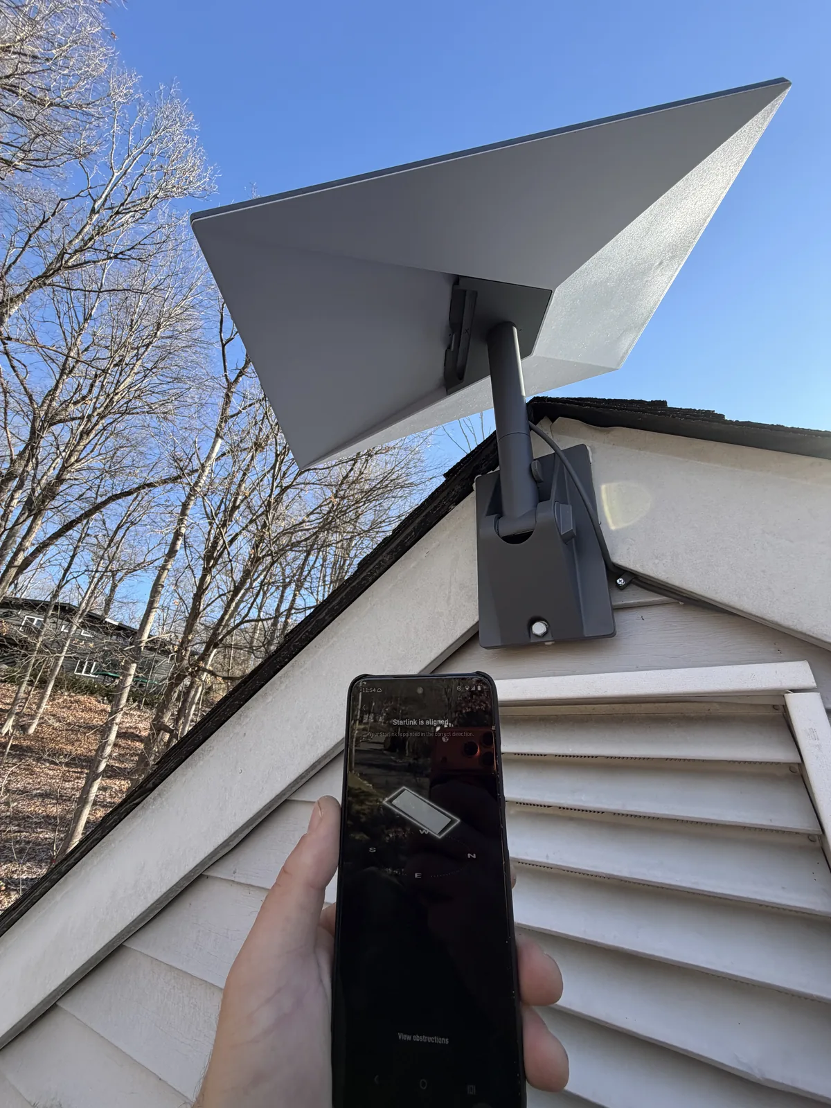 Starlink dish mounted at a roof edge