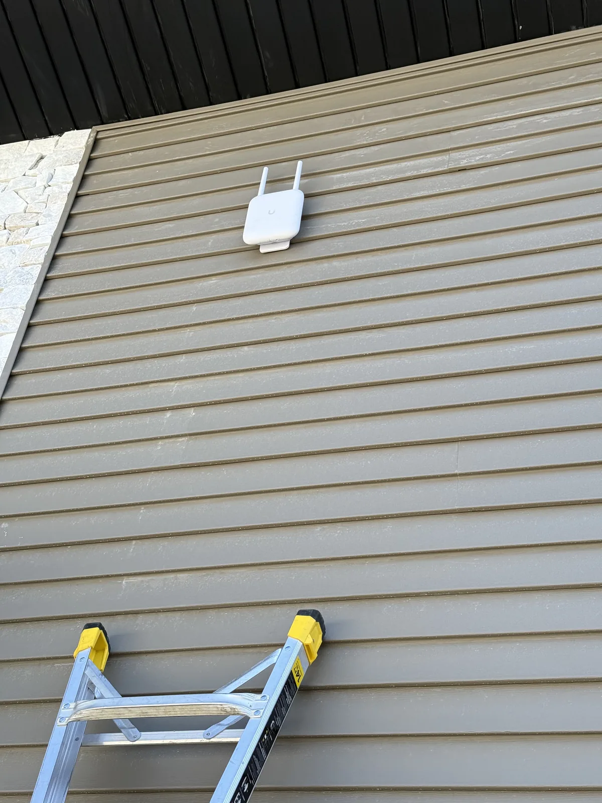 Outdoor wireless access point on siding